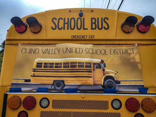 The back of a CVUSD bus with a banner representing the team