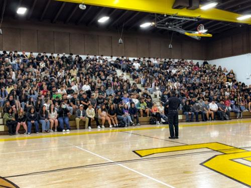 Officer Myles Mason addressing students at the Don Lugo gym