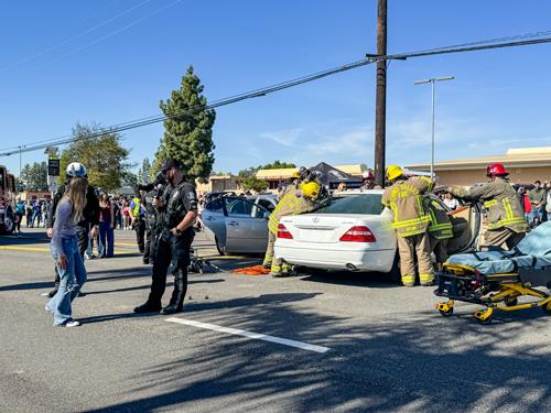 Officers questioning an impaired driver at a staged traffic collision 