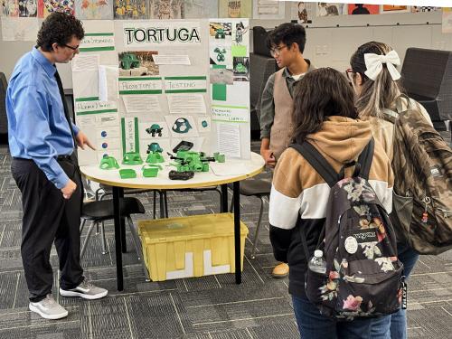 Don Lugo engineering students examining their project