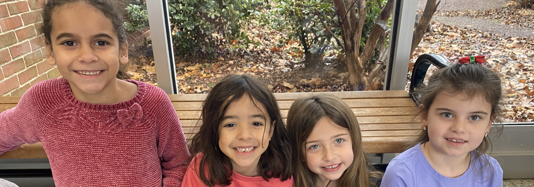 4 elementary girls sitting in hall