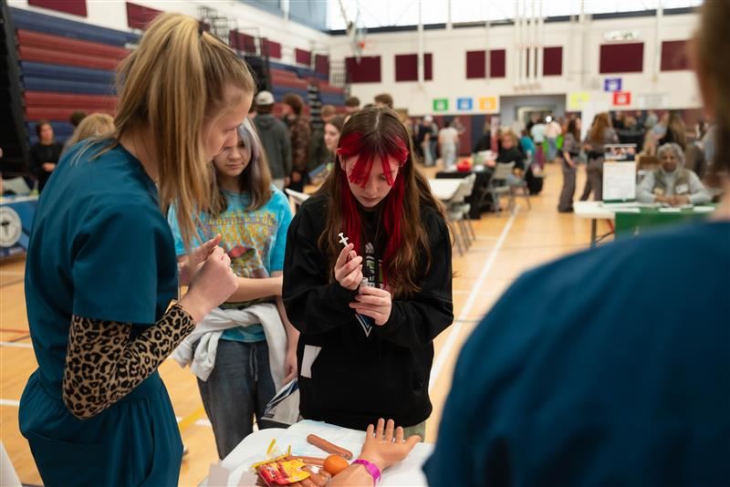  A student engages in a hands-on activity while exploring the Health Careers Expo