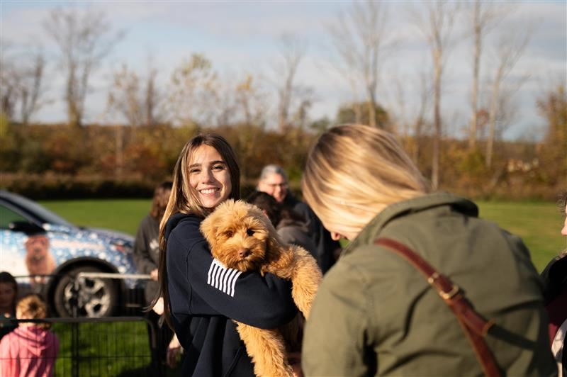A student holding a puppy at the agriculture expo