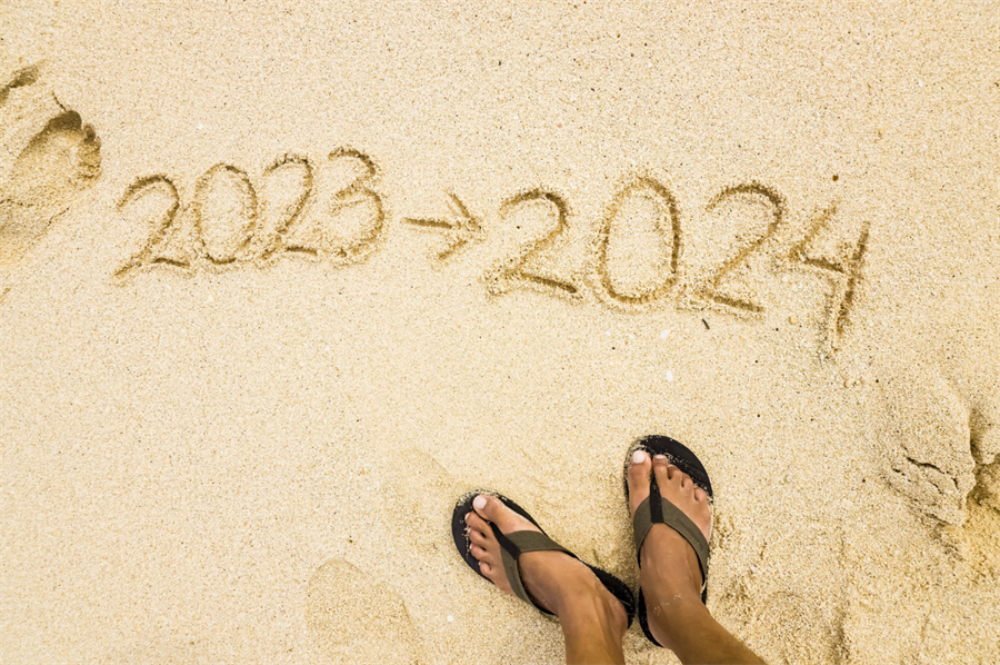 feet with sandals in the sand