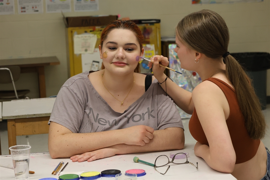 Lecanto HS NAHS Student paints autumn images on another students face
