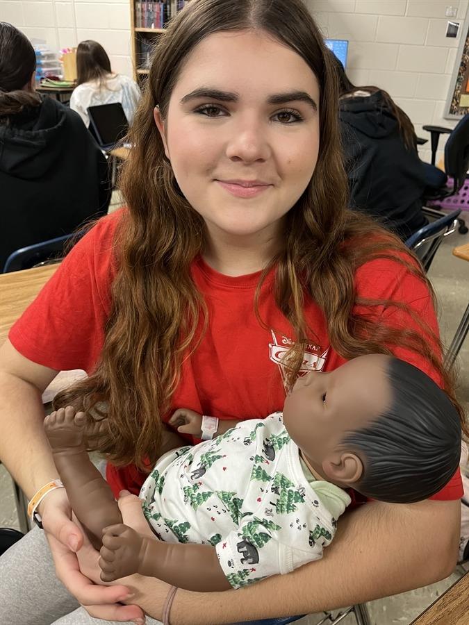 CRHS Student Holding life-like baby