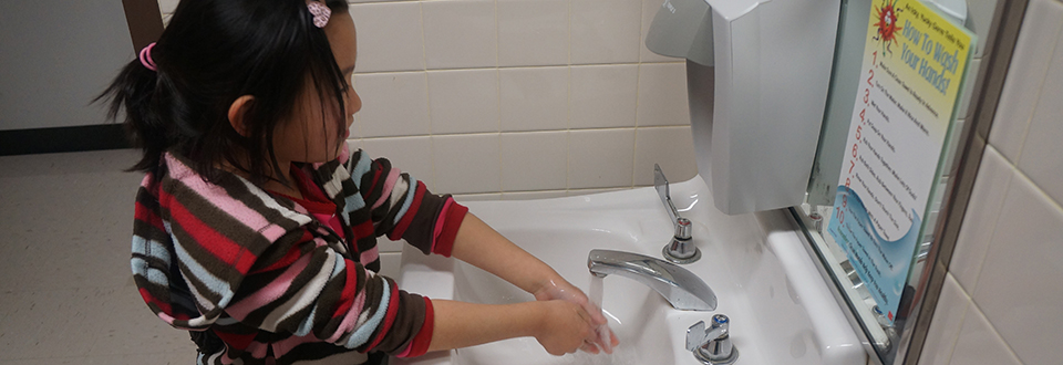 Student washing her hands 