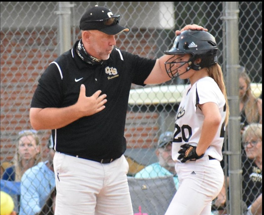Coach speaking with player