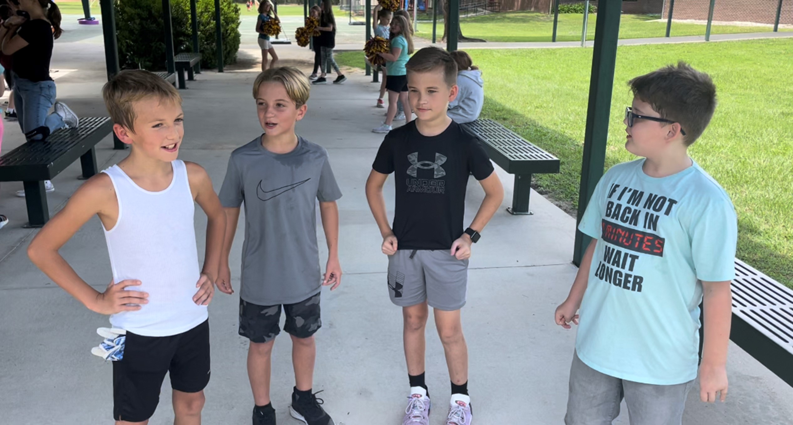 4 boys standing next to eachother