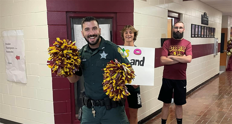 Deputy Barr cheering with pom poms