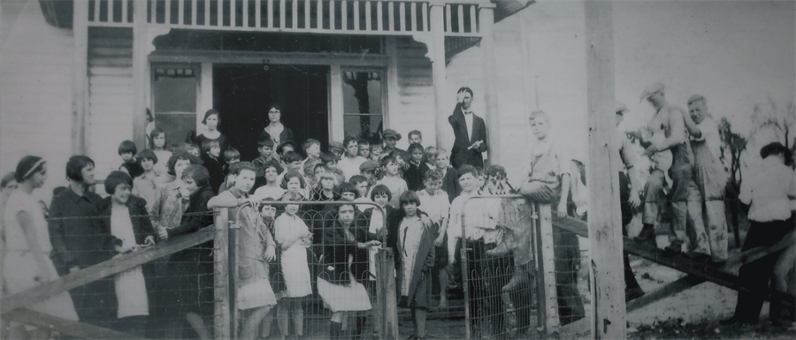 Children standing in front of School House