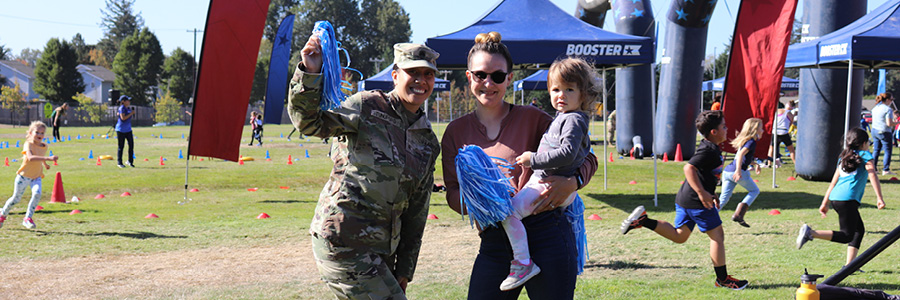 Two mothers and one daughter pose for a photo
