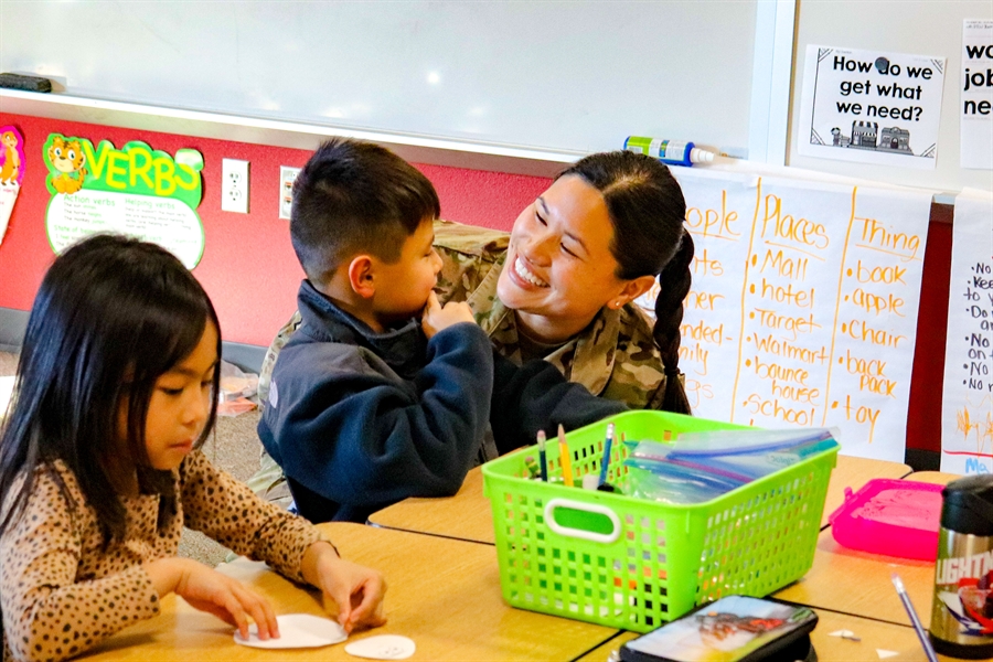 Smiling military mother with student