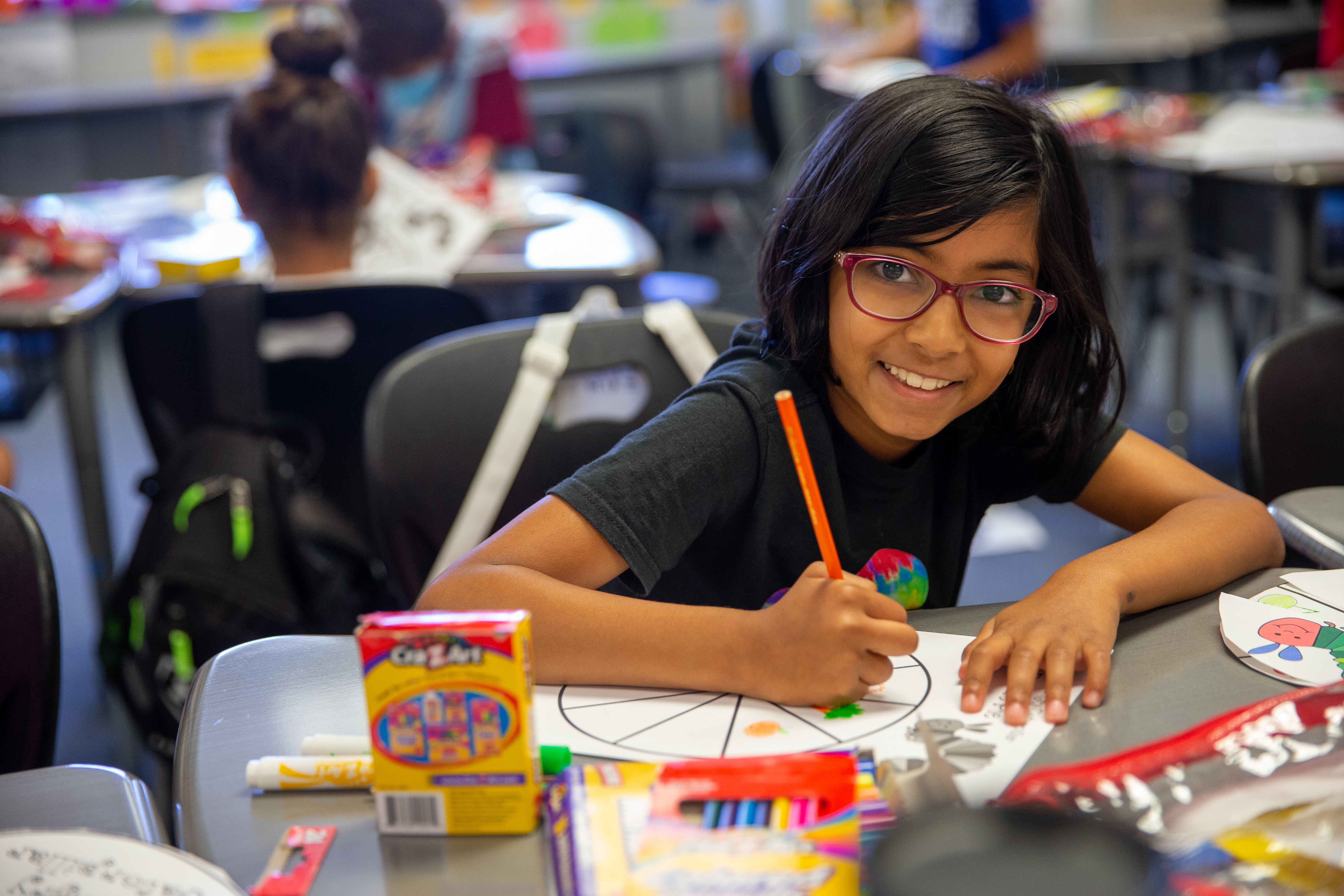 student writing at desk