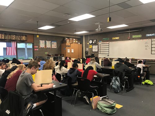 students taking a test in a classroom