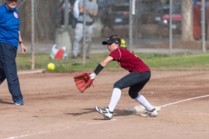 Student catching softball on third base