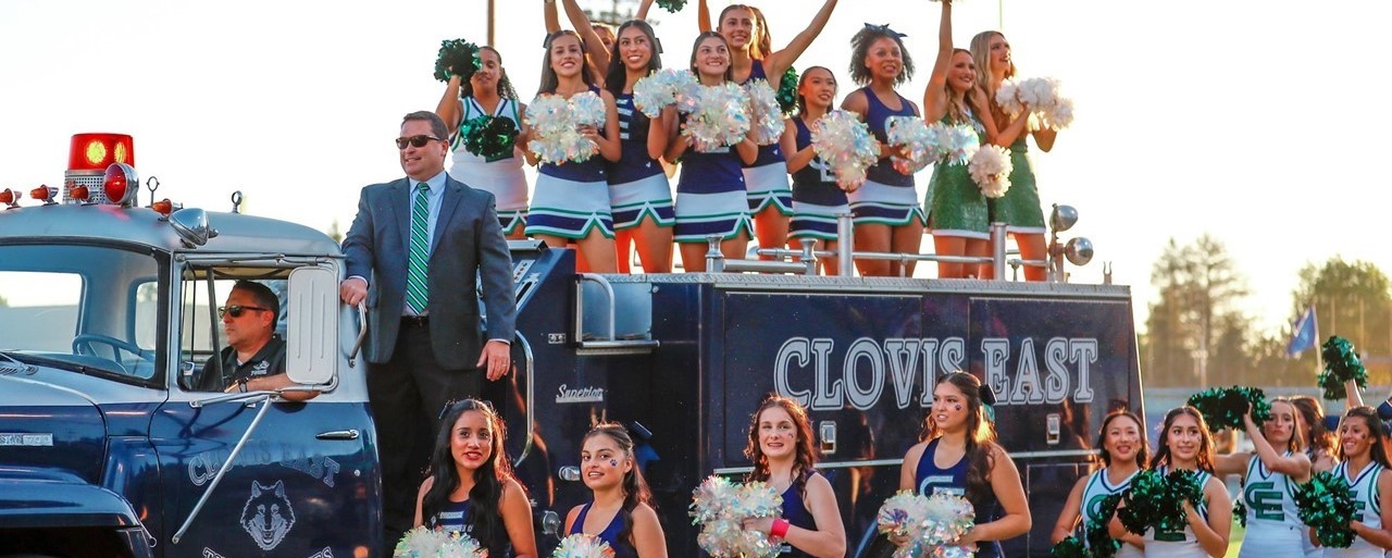 Principal and Cheer on Firetruck at homecoming 