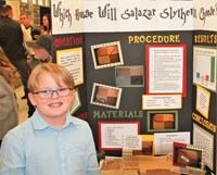 Student picture with science fair board