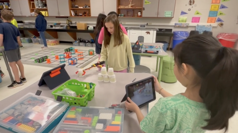 Students at Bailey Station Elementary using Apple devices during a project.