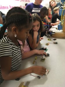 Girls learning how batteries work