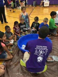 Third grade students experimenting what will float in a pool