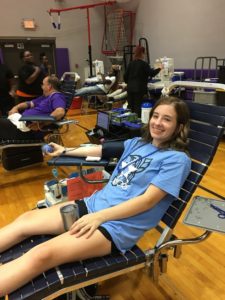 Girl in blue tshirt donating blood