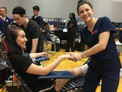 CHS Nursing Students holding hand or girl giving blood