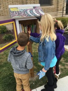 Kids visit the Little Free Library on Clay Street