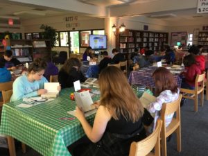 Students reading during book tasting