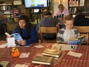 Students reading at book tasting in CHS library