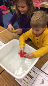 Boy floating a clay boat