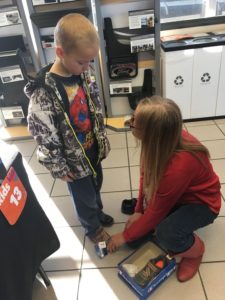 Boy being measured for new shoes