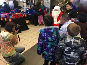 Photographer taking photo of child with Santa