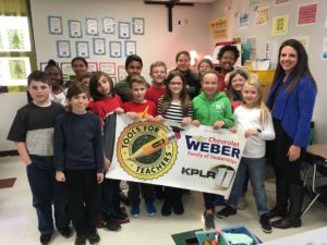 DIS Teacher Hilary Heinlein and students with Tools for Teachers banner