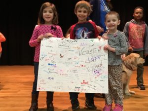 Webster students with Christmas card for Esther the Comfort Dog