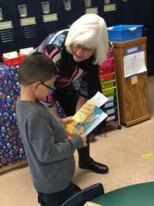 Maureen Schreiber gives book to Kreitner student