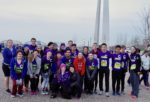 CHS Go St. Louis Half Marathon participants posed in a group photo by the Arch