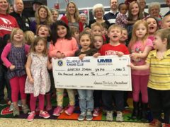 PreK students holding giant check from Sunrise Kiwanis