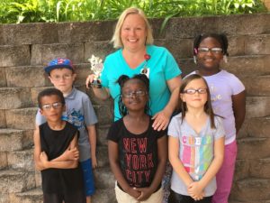 Mary Kay Norberg with students wearing glass 