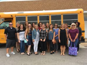 New staff in front of school bus Group 1