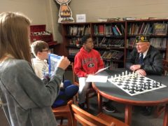 Students Interviewing Veteran in CMS Library