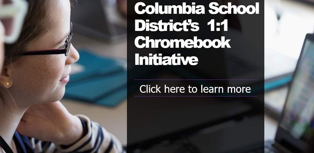 Teacher and Student looking at a Chromebook