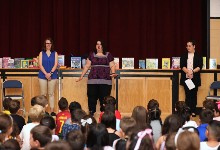 Three local librarians speak with Wood Park students during assembly.