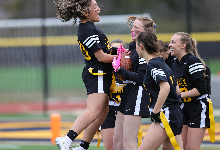 Teams celebrate in the end zone after a first-half touchdown.