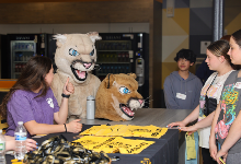 Mack the CHS mascot and student leaders speak with eighth graders. 