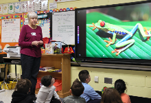 Instructor shows picture of frog to class.