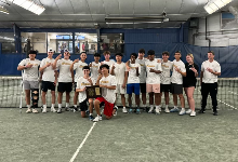 Team poses on court after winning county title.