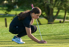 Photograph of eighth grade golfer on course.