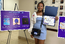 Estelle poses with her certificate and winning artwork.