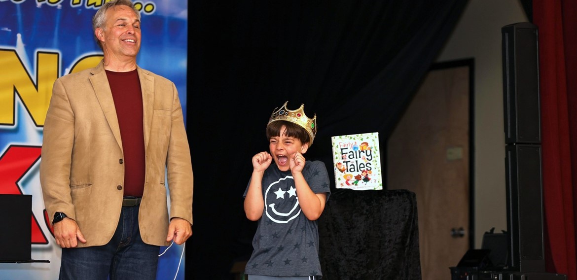 Student on stage during North Ridge Primary reading rocks assembly.